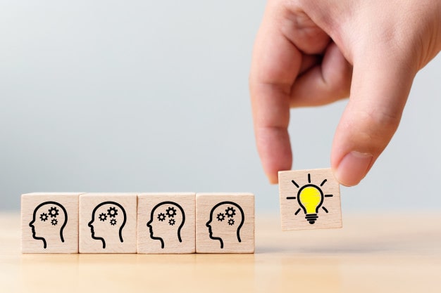 hand-pick-wooden-cube-block-with-head-human-symbol-light-bulb-icon_20693-198-min